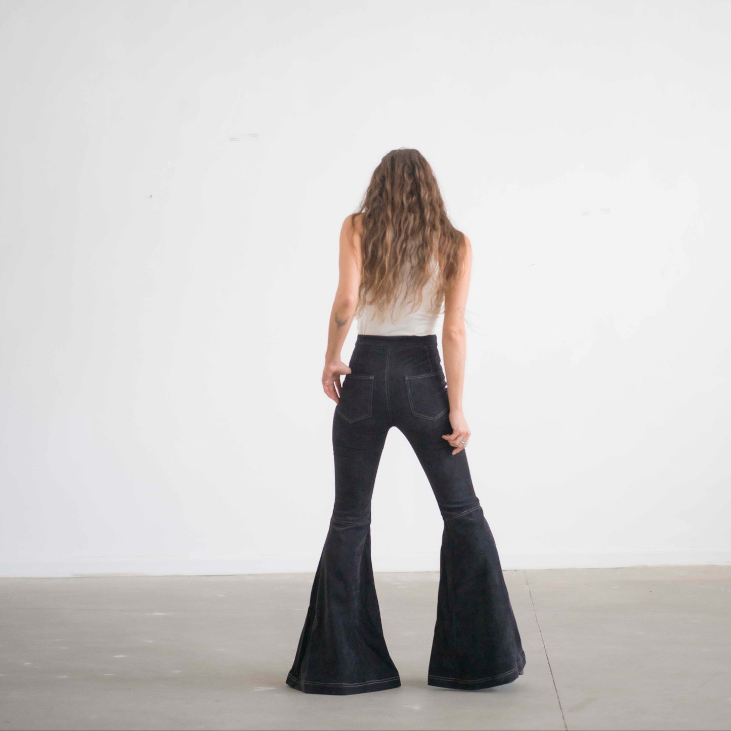 SIMIS The Holly Cord Flares in Black – timeless black corduroy bell-bottom pants with a high waist and flowy flare for an effortlessly elegant silhouette.