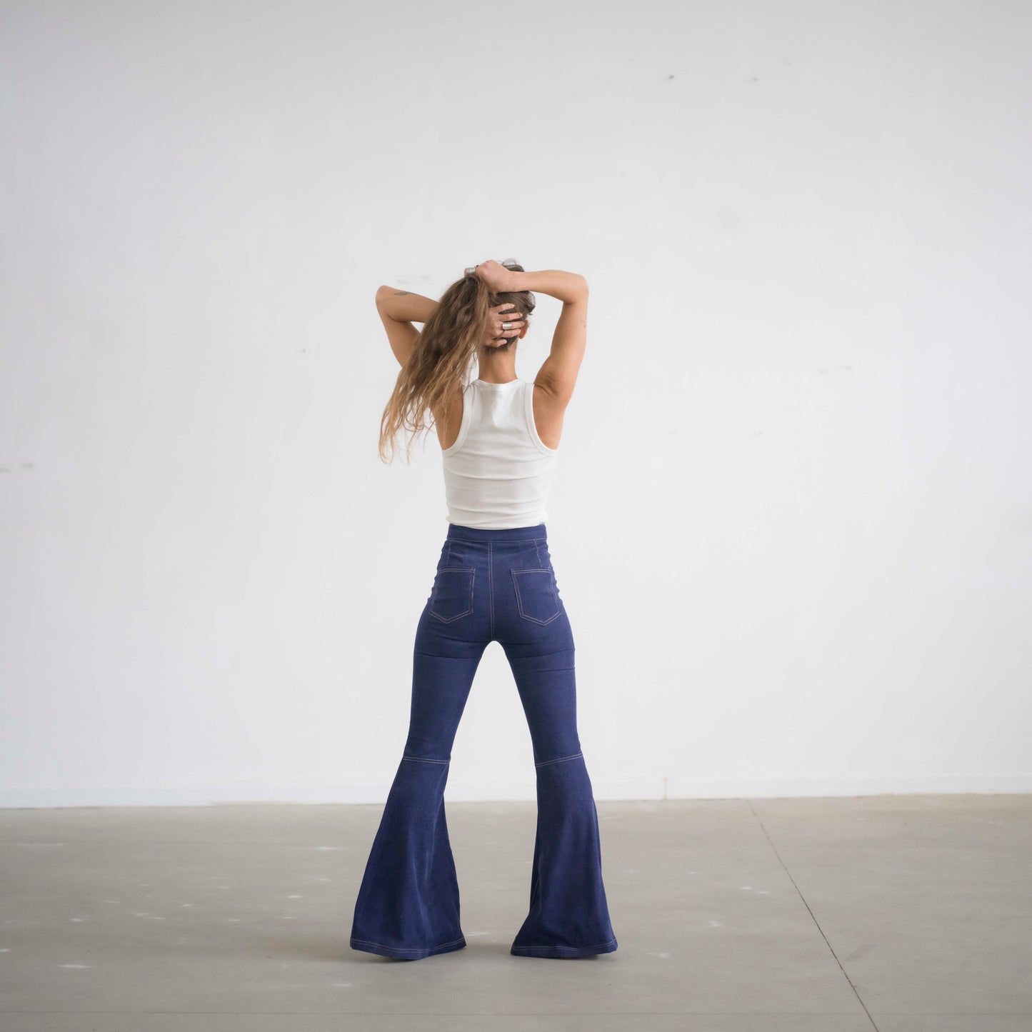 SIMIS The Holly Cord Flares in Indigo – a pair of deep indigo corduroy flare pants, featuring a flattering high-waist fit and leg-lengthening silhouette.