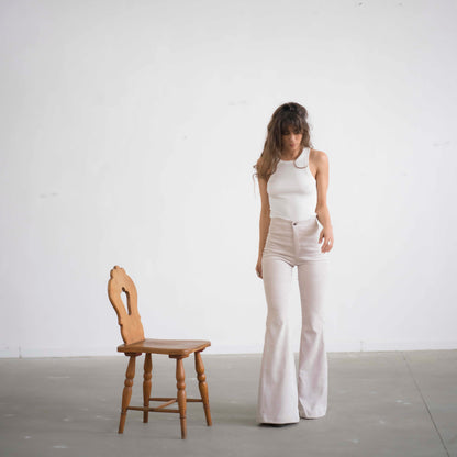 SIMIS The Holly Cord Flares in Off-White – a pair of elegant off-white corduroy flare pants with a high waist and elongating cut, perfect for a sleek and sophisticated look.
