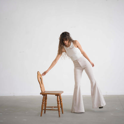 SIMIS The Holly Cord Flares in Off-White – a pair of elegant off-white corduroy flare pants with a high waist and elongating cut, perfect for a sleek and sophisticated look.